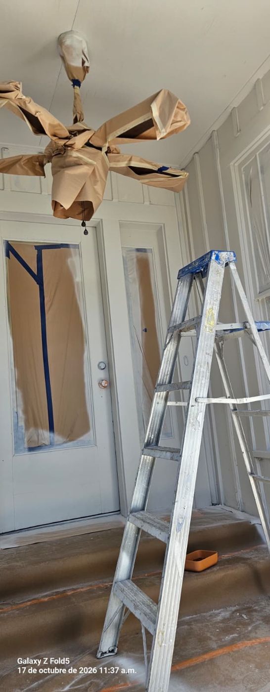 Front porch doors masked with ladder in place for painting
