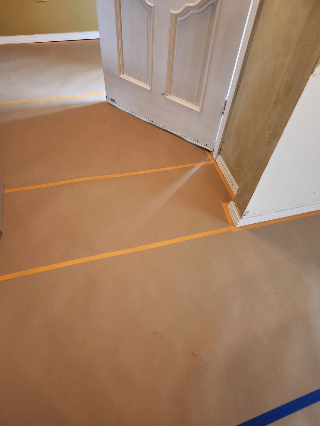 Door and walls covered with masking paper before painting