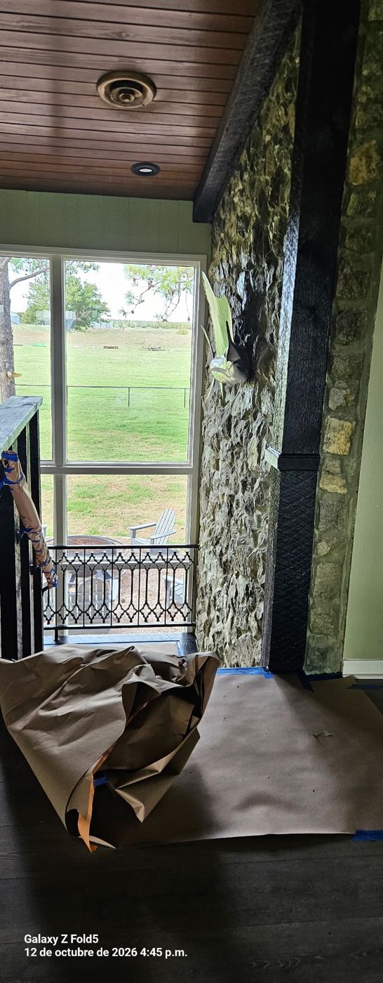 Interior room with stone wall and floor protected with paper