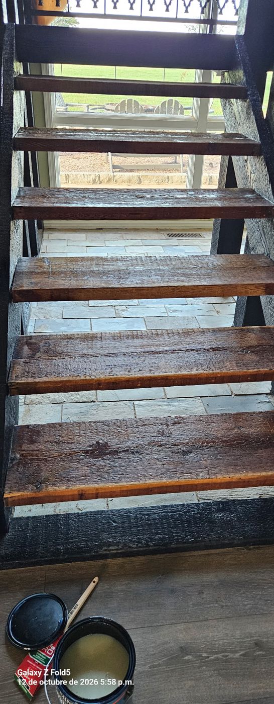 Staircase with stained wood treads and black painted frame